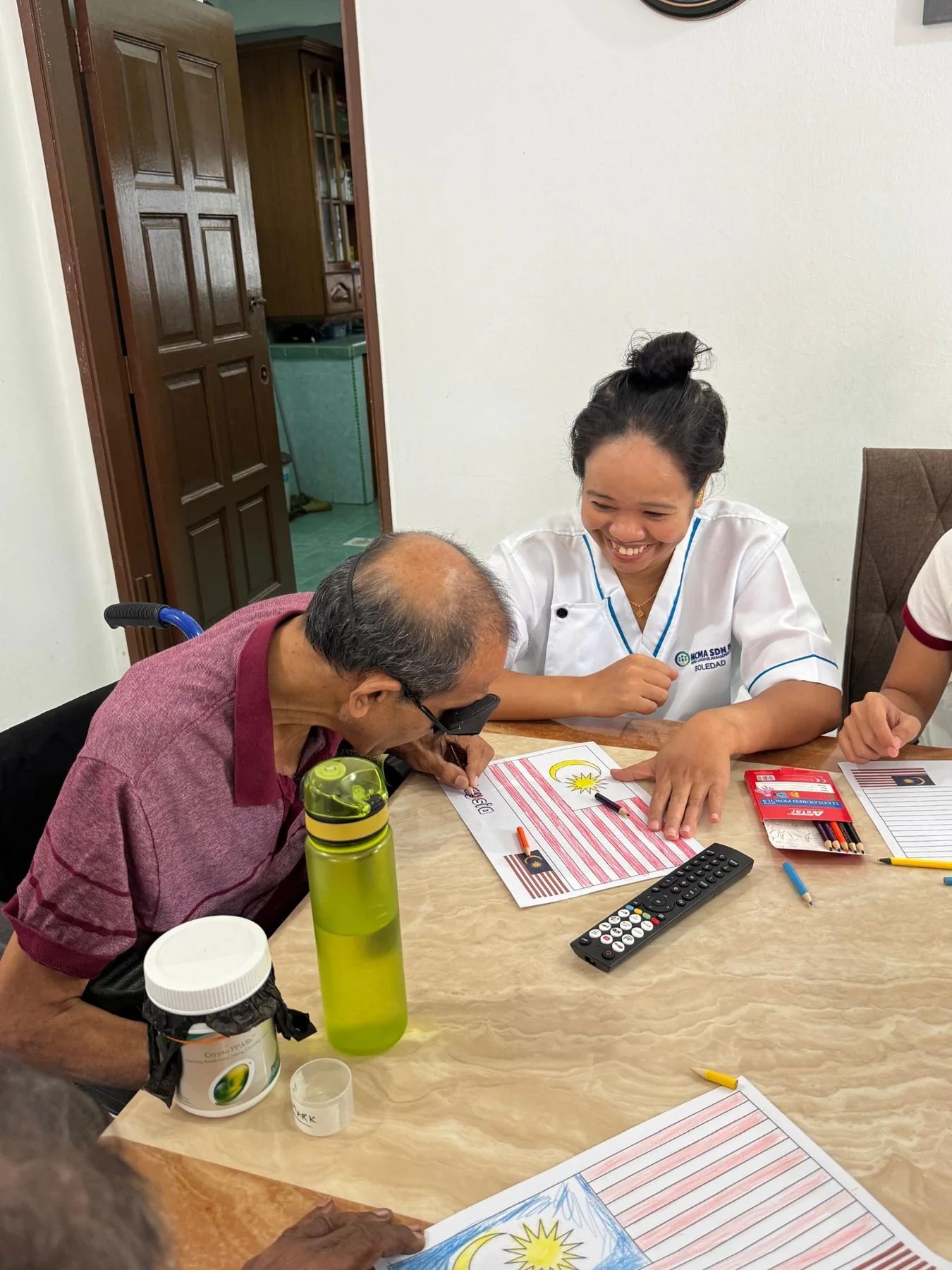 Caregiver helping a resident with an activity