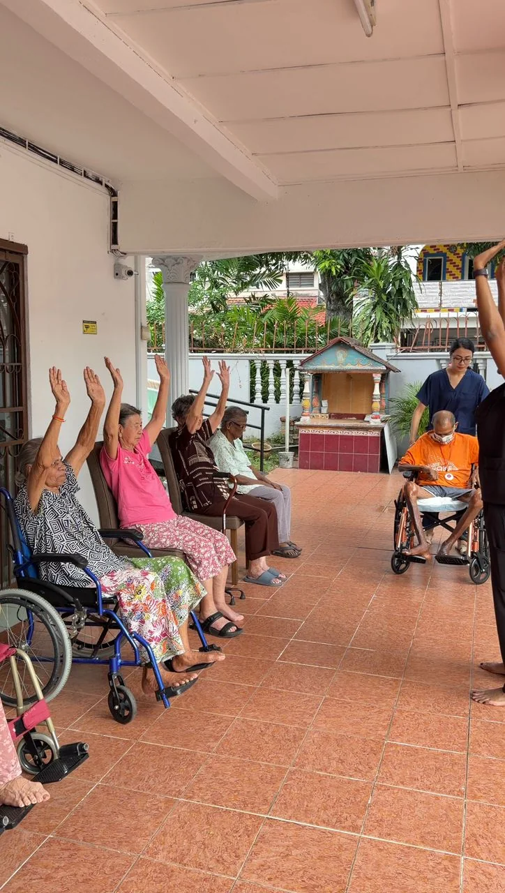 Residents doing outdoor chair exercises