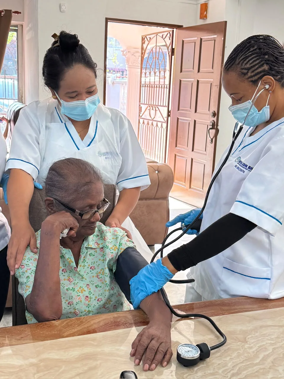 Care staff conducting routine health monitoring